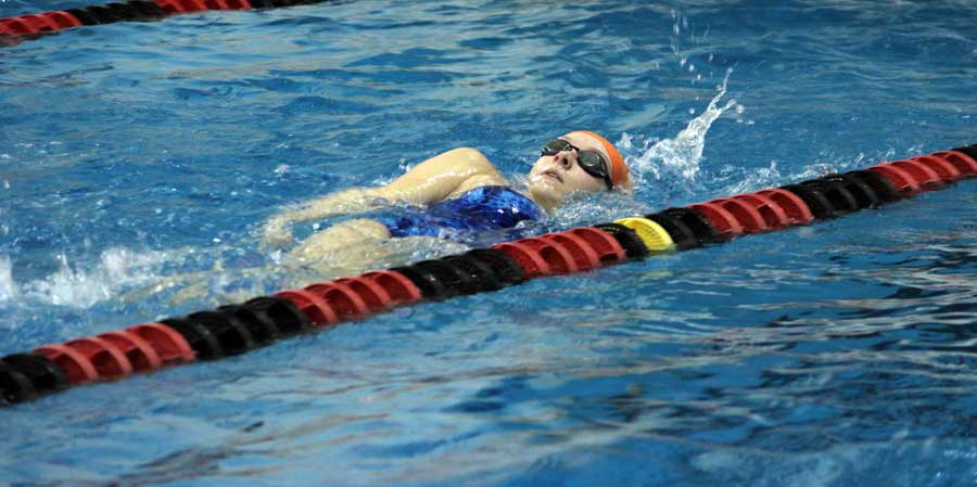 Sophomore Sydney Lechner swims backstroke in the teams meet against Francis Howell North. The girls won this meet 111-62.