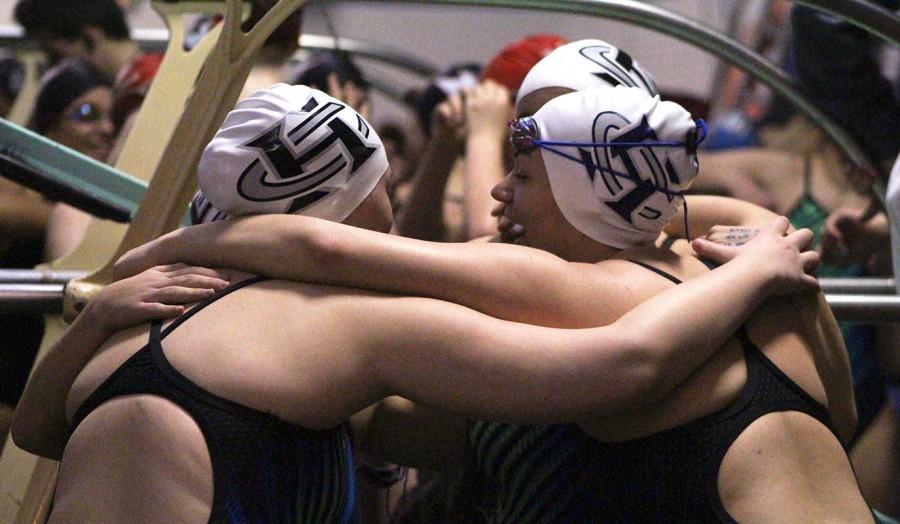 The girls swim and dive team huddle up and congratulate each other after an event at the Ozark Invitational.  The girls placed fourth overall out of 20 teams in this invitational.