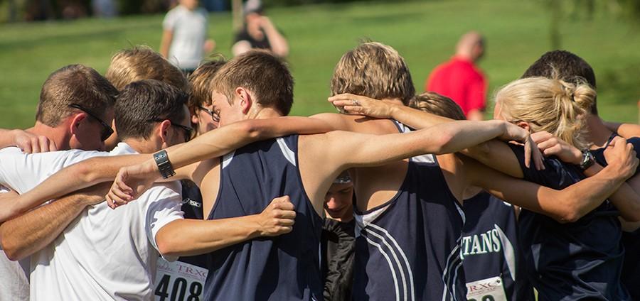 The boys cross country team huddles up before their meet on Aug 29. They were among the top teams in the outstanding award category with an average GPA of 3.92.