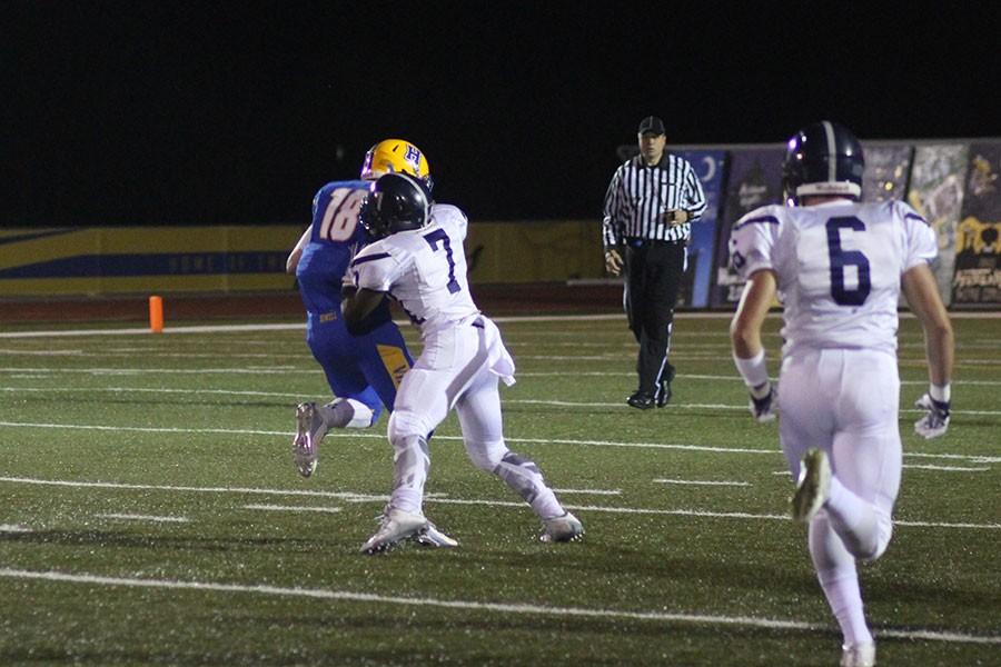 Running back Jordon Cooper makes a tackle during first half. The Spartans lost 7-42.