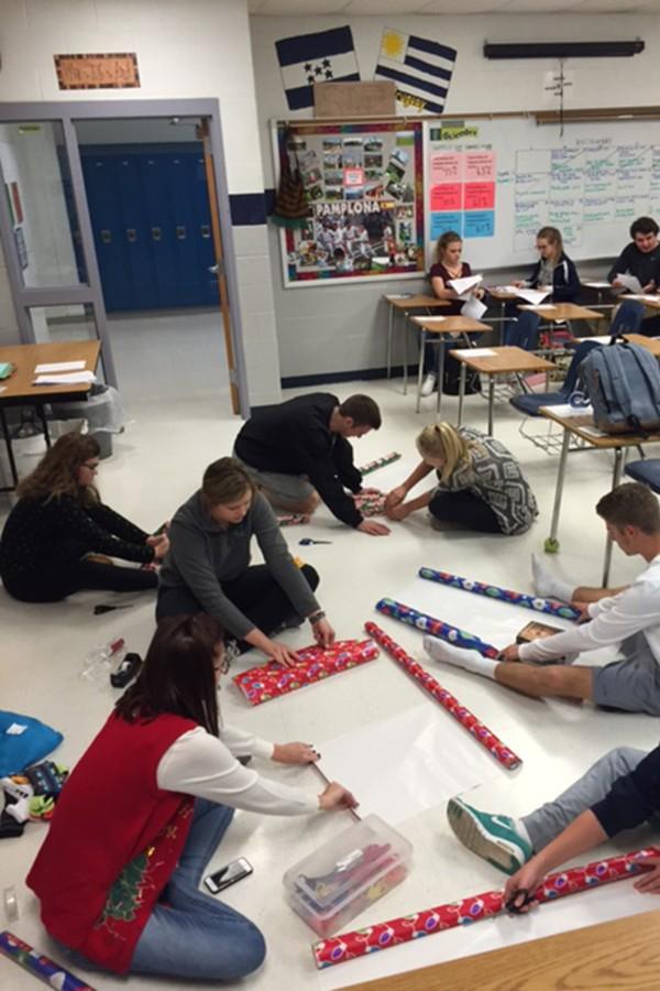 Students wrap presents that were bought by the donation money.