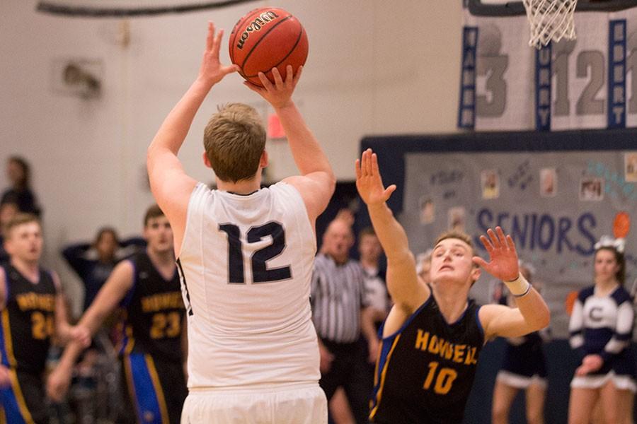 As Clark Hepler makes a shot, Howell's Zach Reader attempts to block his shot.