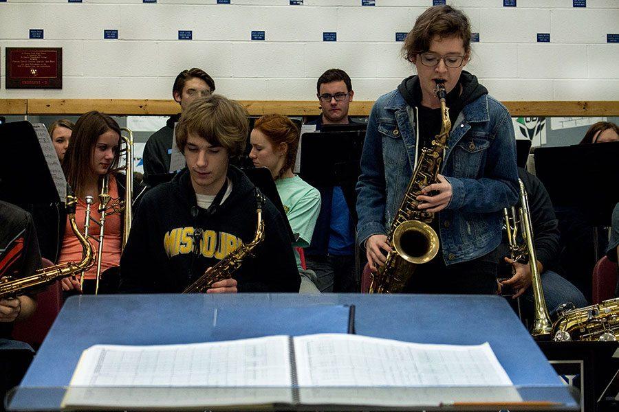 Jazz ensemble students, including junior Vivian Scott (right, standing), practice a piece.