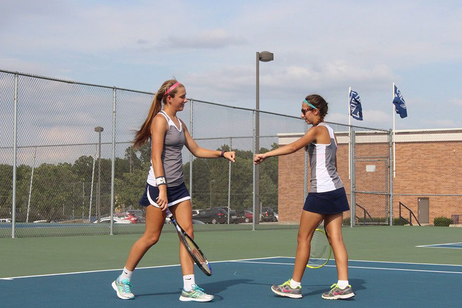 Sisters, Angel and Tori Ikeda, celebrate on the court.
