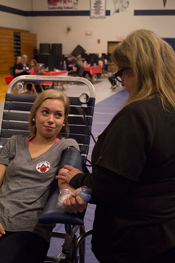 Senior Rachel Emery keeps her eyes on a nurse from the Mississippi Valley Blood Center while preparing to give blood at StuCos annual blood drive on Oct. 25.
