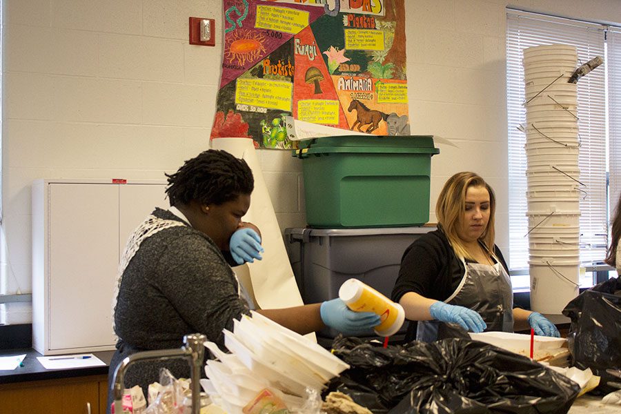 Junior Patricia Dees gives a look of disgust during the lab in Mrs. Paula Pettig’s class. The students participated in a lab where they sorted through trash bags.