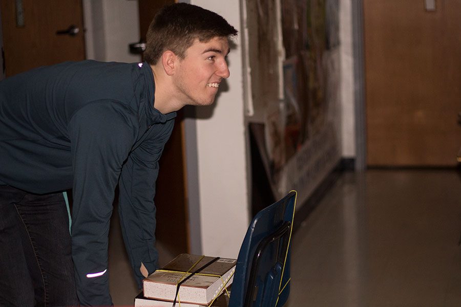 Eyeing his target, junior Austin McKinley prepares to push a rolling chair as a part of the Office Olympics he created with two other students in Mrs. Laurie Penuel's classroom during the power outage on Jan. 25. The outage lasted more than two hours before students were dismissed for the day. 