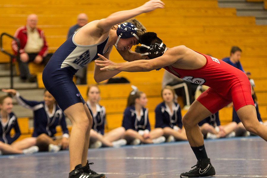 Sophomore Nick Mallon evades a locking move from his opponent in his varsity match. The team is laser-focused on another consecutive state title for this years season.  