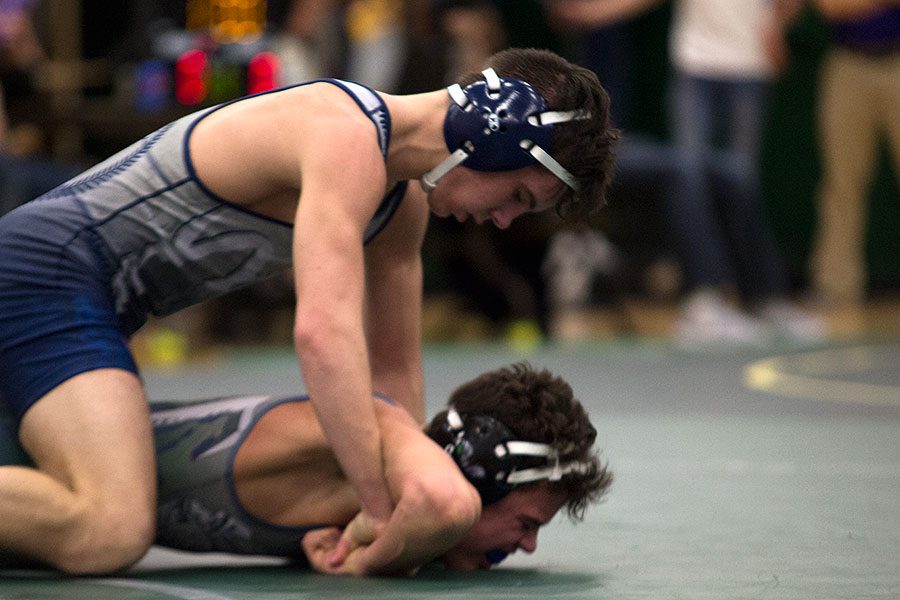 Sophomore Andrew Godier pins down his opponent from Timberland. He went on to win first place for his weight class and a spot in the state tournament.