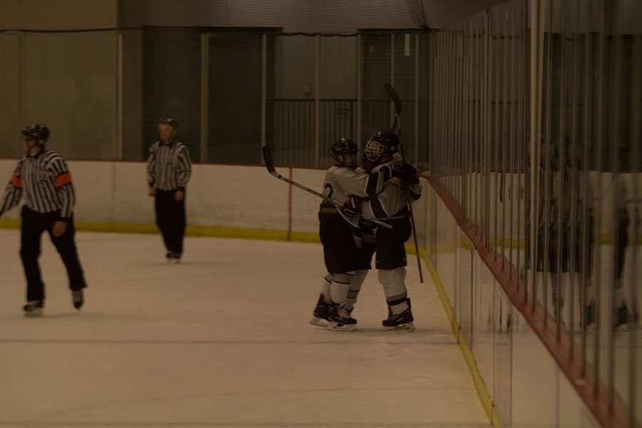 Spartan hockey players celebrate after a goal. The Spartans turned the game around with Moats goal in the third period.