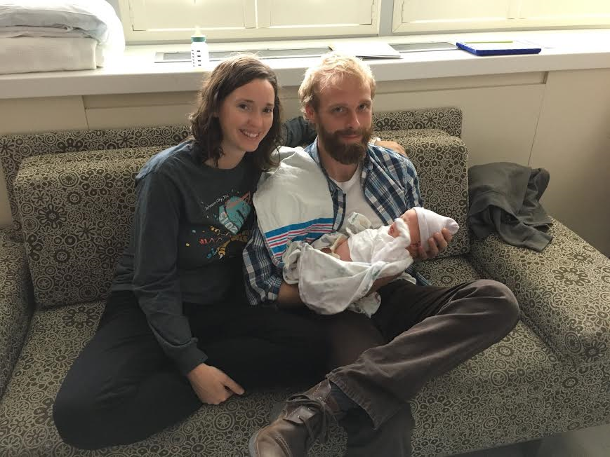 Adoptive parents Mike and Jessie smile while holding their new son.  Cato is very grateful to have them as apart of her family