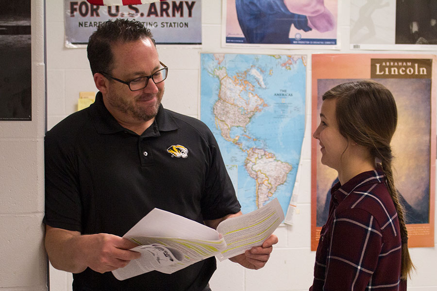 Mr. Lober helps a student with her work. Mr. Lober teaches both AP European History and World History. 