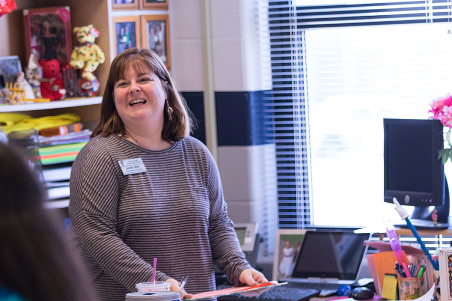 Dr. Miller grins with a student. Dr. Miller teaches Spanish 2 and 5. 