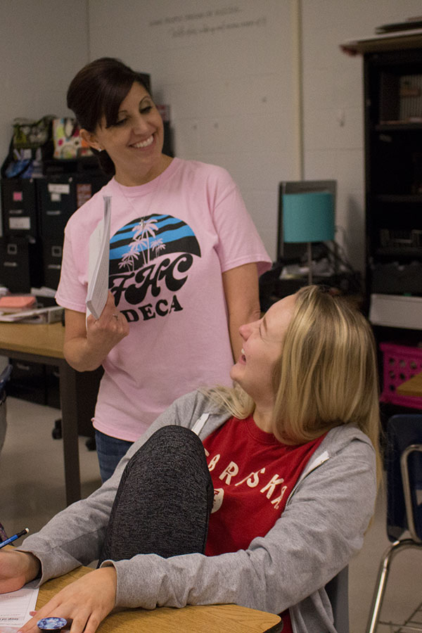 Mrs. Schafer laughs with a student during class. She teaches both Economics and Marketing. 