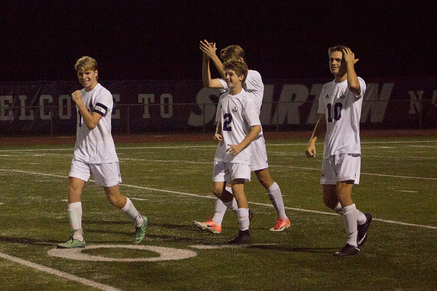 Spartan players are relieved after they finish off St. Dominic in penalties.  Kurtis Ralston (far left)  made the penalty kick in the sixth round to end the game.