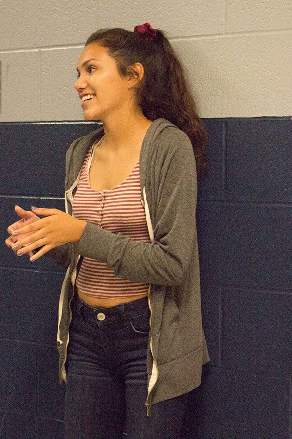 Senior Carlin Bippen claps the rhythm of second movement for this year’s marching band show. Teaching your section the rhythm is a crucial part of the fine tuning of the show.