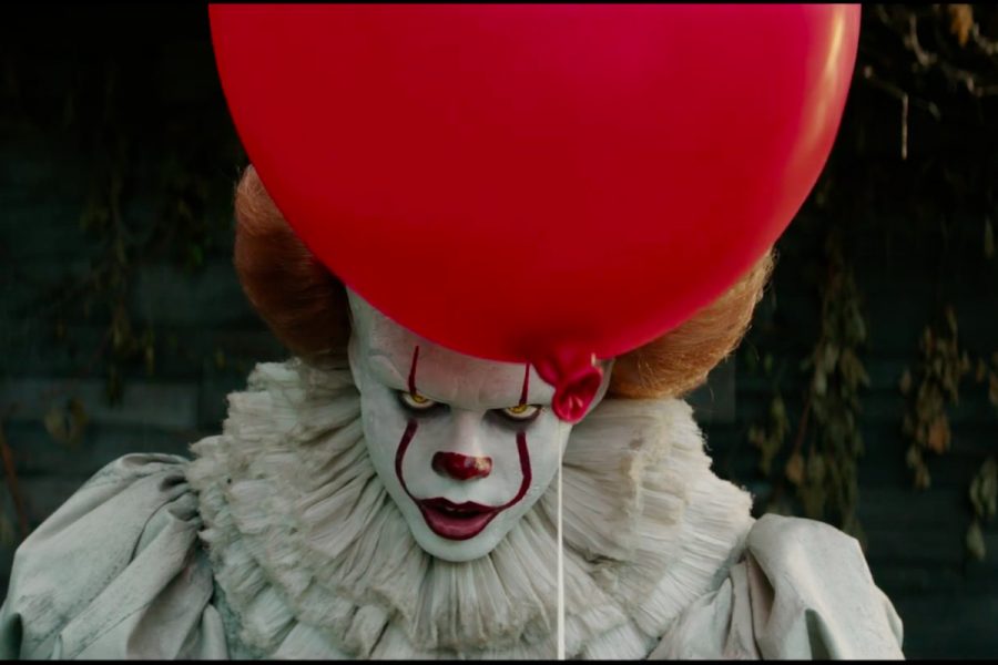 Pennywise+the+demonic+shapeshifter+appears+from+behind+his+primary+foreshadower%3A+a+bright+red+balloon.+Pennywise%2C+played+by+Bill+Skarsg%C3%A5rd%2C+is+now+a+renowned+contemporary+horror+antagonist+for+his+incredibly+unsettling+characteristics.