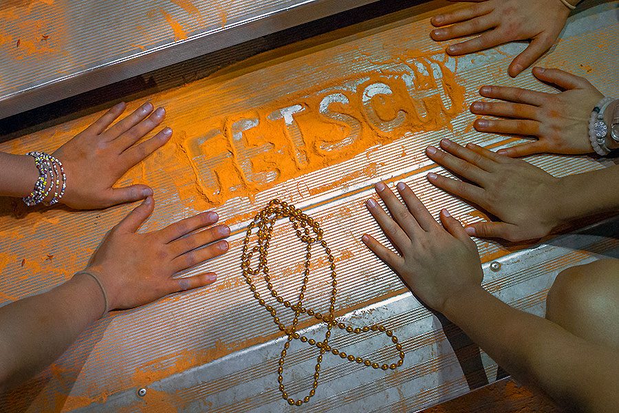 After orange flour was tossed in the air at the Sept. 15 football game against Troy Buchanan, students spelled out Roxanne Fetschs last name in leftover flour and made a ribbon out of orange beads. 