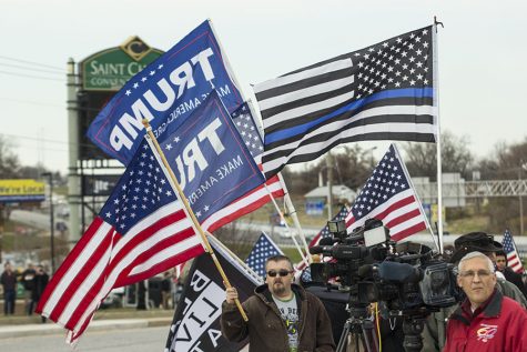 Protesters outside the St. Charles Convention Center wave Trump flags while awaiting his arrival. President Trump traveled to St. Charles to speak about tax cuts. 