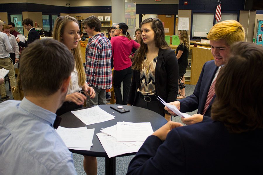 A group of students discusses their experiences at the DECA mini-competitions held Nov. 15 in the Learning Commons. The mini-competitions are essentially a practice opportunity for students who will head into DECA competitions later in the school year. 