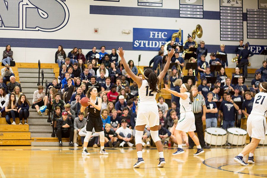 Junior+Yani+Curry+%28%2312%29+locks+down+a+defensive+line+with+fellow+senior+guard+Makenzie+Schierding+%28middle%29+against+the+FZS+Bulldogs.+The+varsity+girls+team+is+known+for+their+shock-and-awe+playing+tactics%2C+but+have+been+working+on+building+strong+defenses+for+the+second+half+of+games.