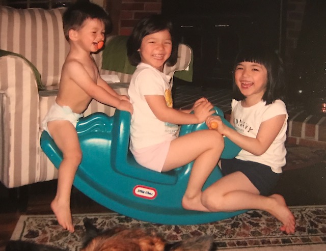 The Chung siblings having a blast while trying to fit all three of them on one rocking horse.