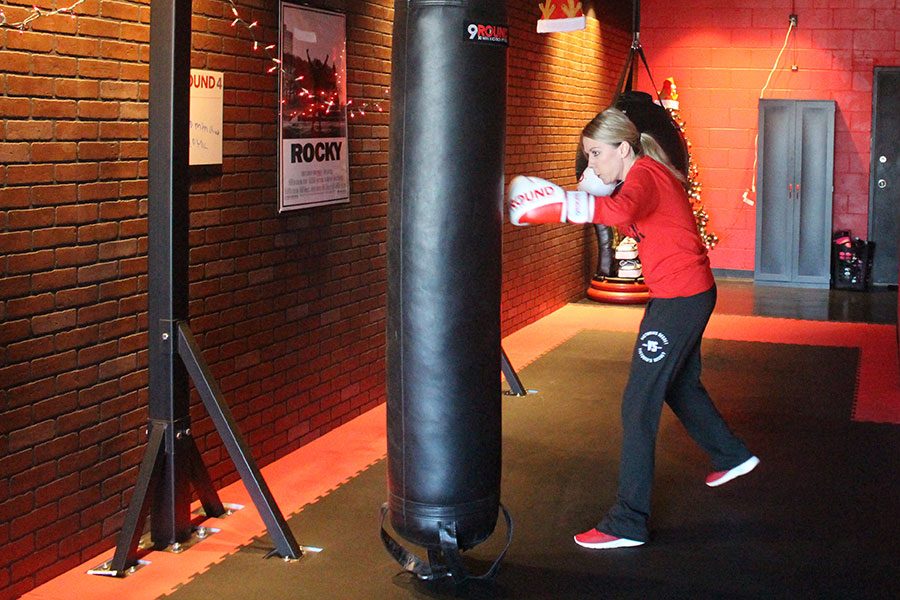 Marlene Twehous throws a punch at a punching bag at 9Round, the boxing gym she owns. 