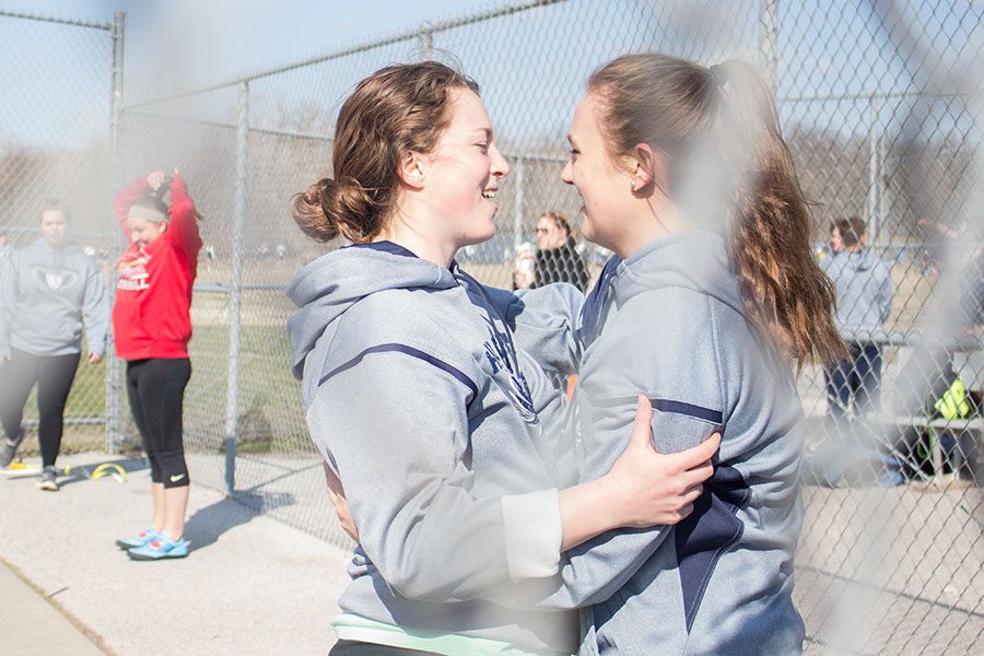 Embracing before beginning their competition, throwers Abigail Green and Mackenzie Schierding hug on Wednesday. Green just recently earned and accepted an appointment to throw at West Point Military Academy. 
