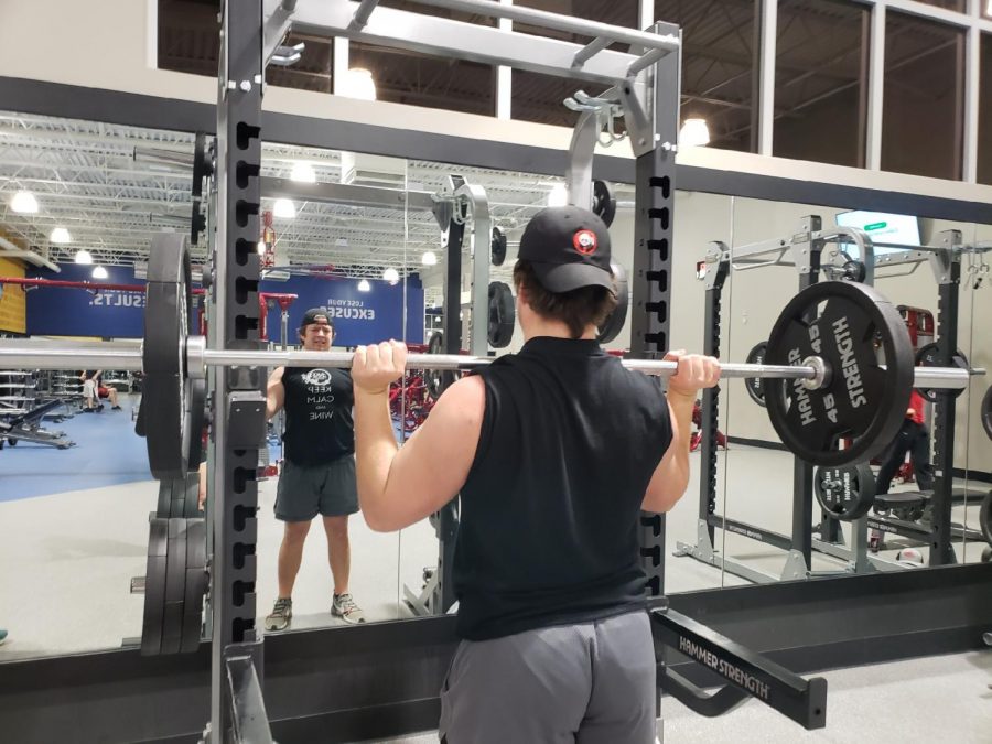 Senior Zac Bishop is working out is upper body muscles with a workout called, Military press. This is used to strengthen a persons shoulders and deltoids. 