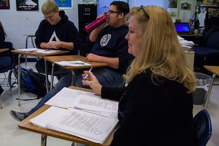 Mrs. Shockley sits in the middle of a discussion. She is making sure her students are understanding what they are discussing. 