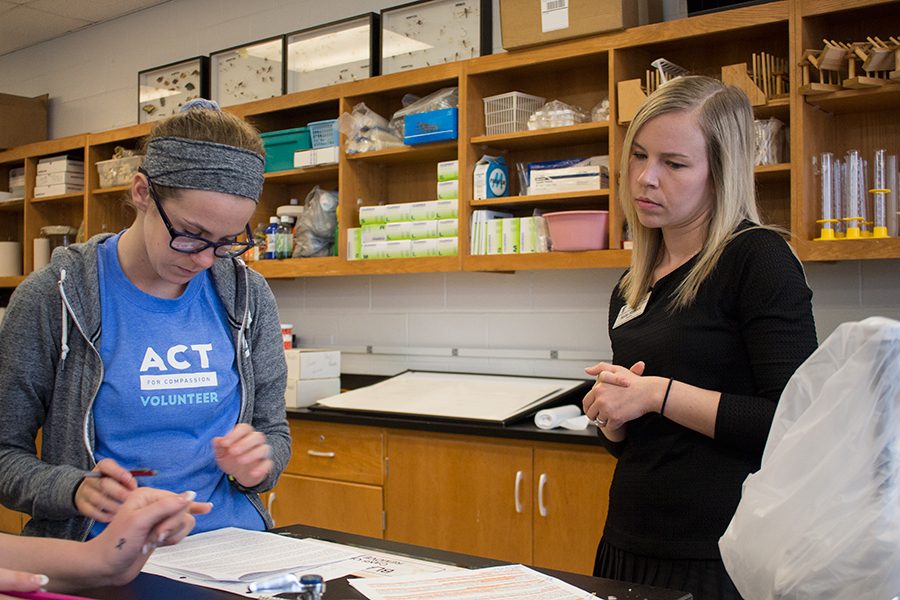 Mrs. Staback helps a student in lab. She is watching as her students complete their work. 
