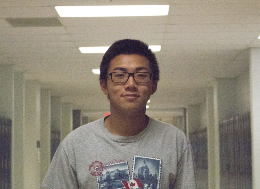 Swimmer Michael Yu poses for a headshot after giving an interview on what's new with Boys Swim.