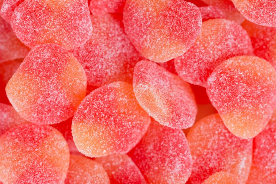 Haribo gummy peaches lay beautifully with each other. This sweet candy provides a satisfying peach flavor.