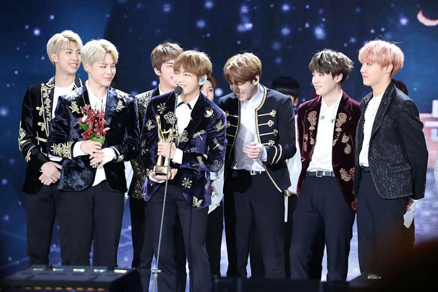 The worlds biggest boy band, BTS, accepts their award for winning the album division at the 31st Golden Disk Awards. Members RM, Jimin, Jin, V, Jungkook, Suga, and J-Hope (named left to right) all wear proud smiles.