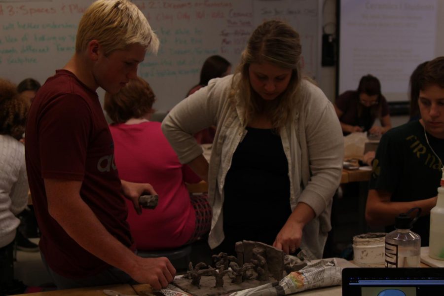 CREATE: Mrs.Sprick helps a student during her first hour ceramic class. 