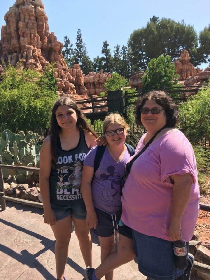 Sydney Love stands with her mother and sister while on vacation. Despite being sad that her parents separated, she recognizes theyre both happier now. 