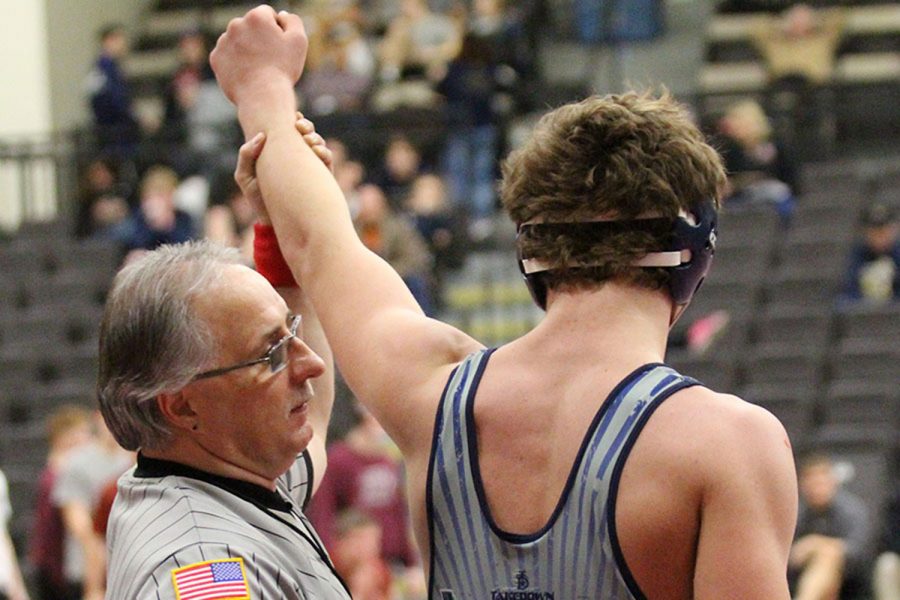After a hard won match, Weston Klein has his fist raised in the air in victory by the referee. Victory was a common occurrence at the match on December 1, where two of the Spartan wrestlers came out undefeated.