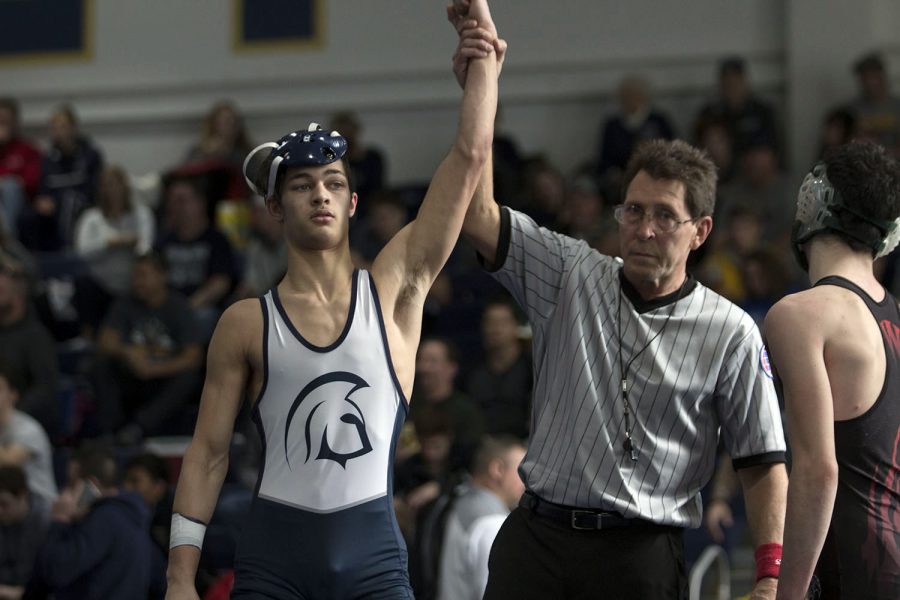 Junior Bryce Alberty allows his hand to be raised in victory by the referee. Like many others at district, Alberty performed well and represented FHC to the best of his ability.