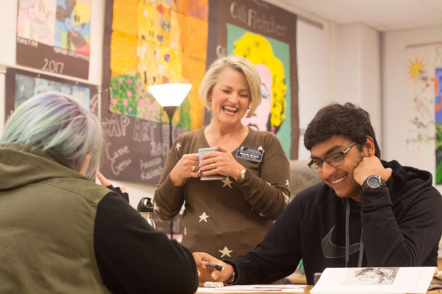 Senior Rishith Mishra laughs along with Michelle McCune during AP Art History. Mishra talks Mrs. McCune about his life because he knows that she will listen and help him problem-solve. 