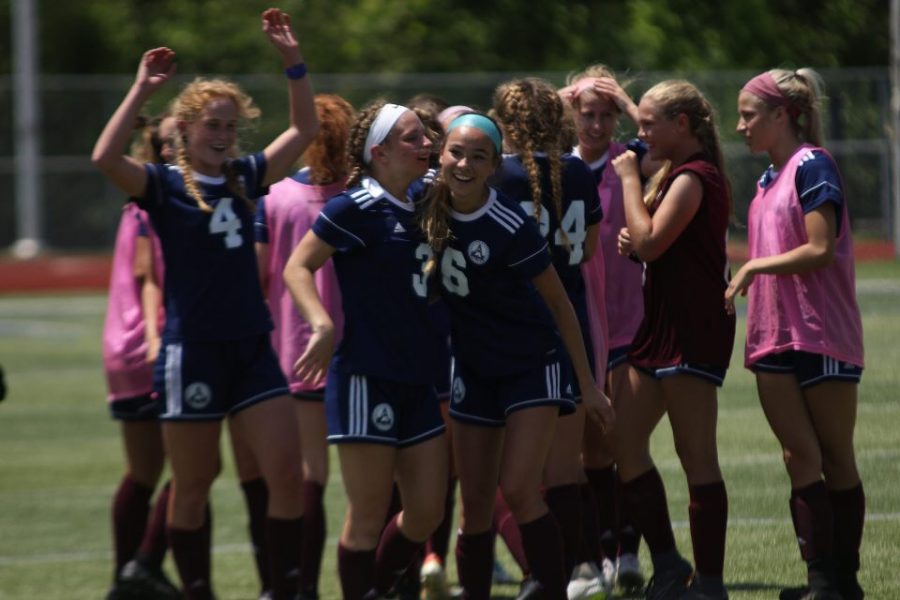 The girls soccer team celebrates after winning the District 4 Quarterfinals game against Howell