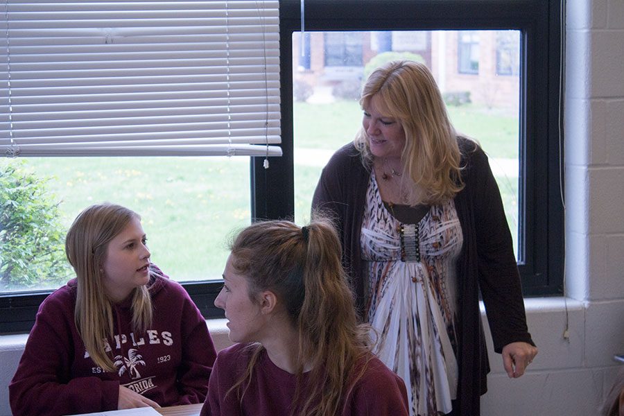 Mrs. Shockley talking with a student during class