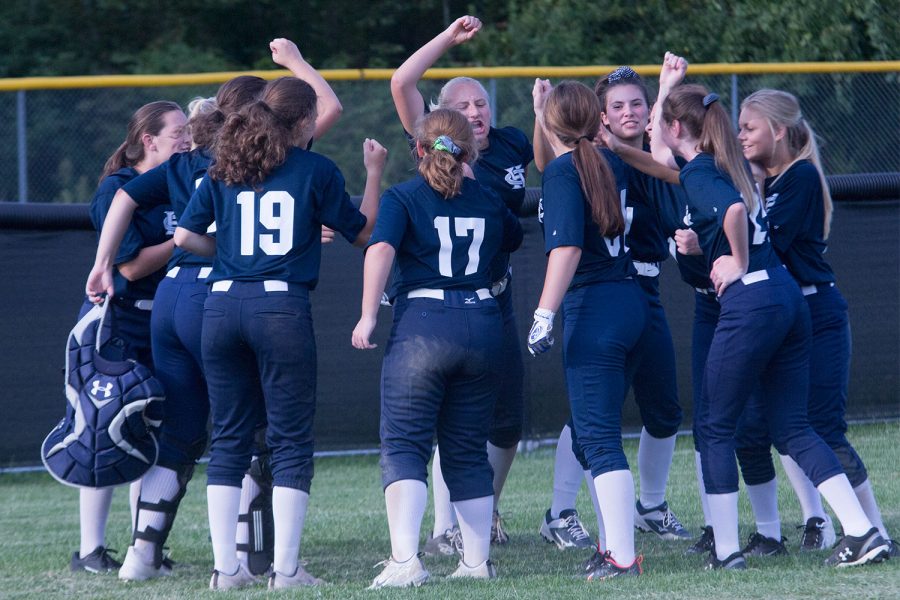 The girls softball team celebrates at the end of another victory. They had a very successful first week of the season, with 4-1 win streak.