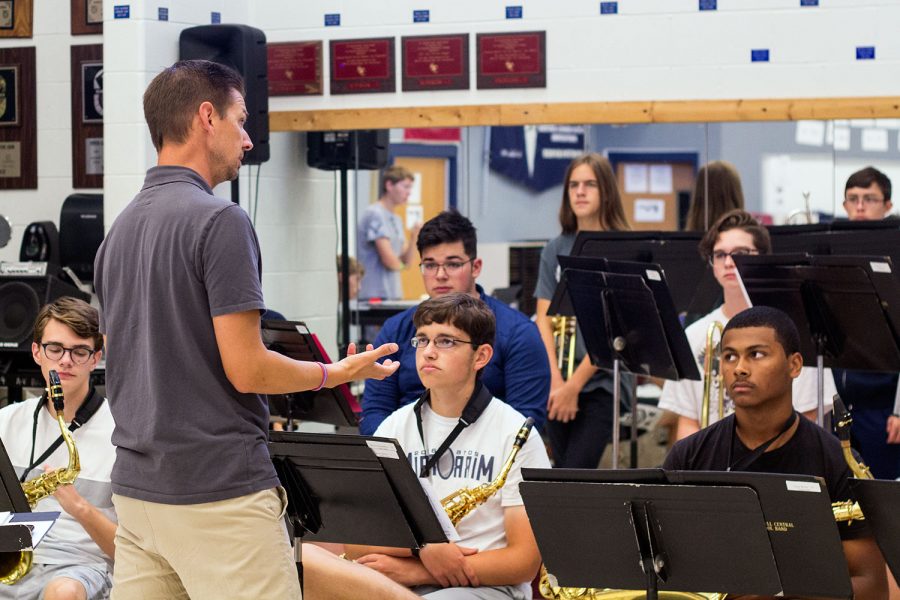 Mr. Nathan Griffin speaks with members of one of the school bands.  The Jazz Band is in search of a bass player to round out its sound.