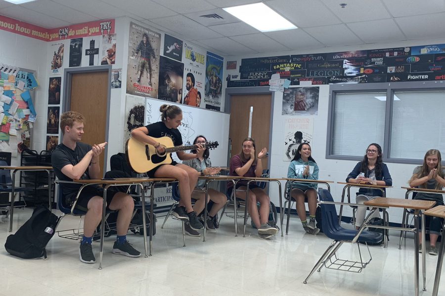 JAM SESSION: Alli Rush plays a song on her guitar for her English class, much to her classmates delight. Rush brought her guitar to school for extra credit on a Spanish assignment and played for her other classes as well. 