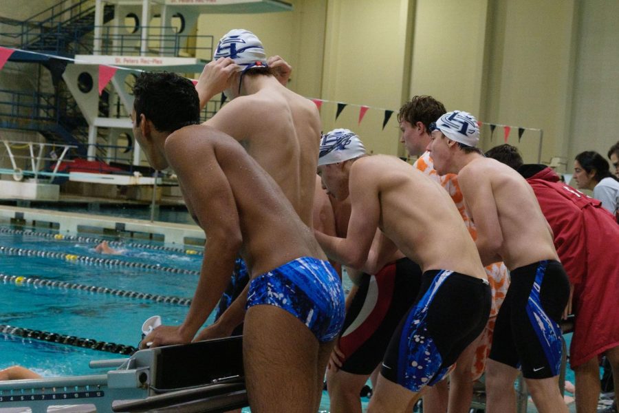 GOING ALL THE WAY - FHC Swimmers cheer on their fellow teammate as they swim their event. The team all encourages each other to swim their best, regardless of the outcome of the event.