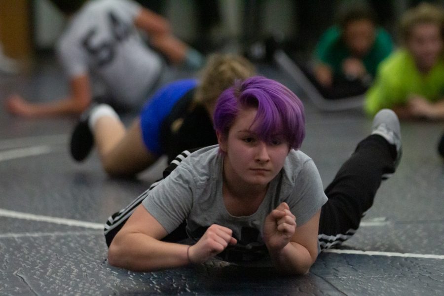 Female wrestlers practice as they prepare for their first match on Dec. 12