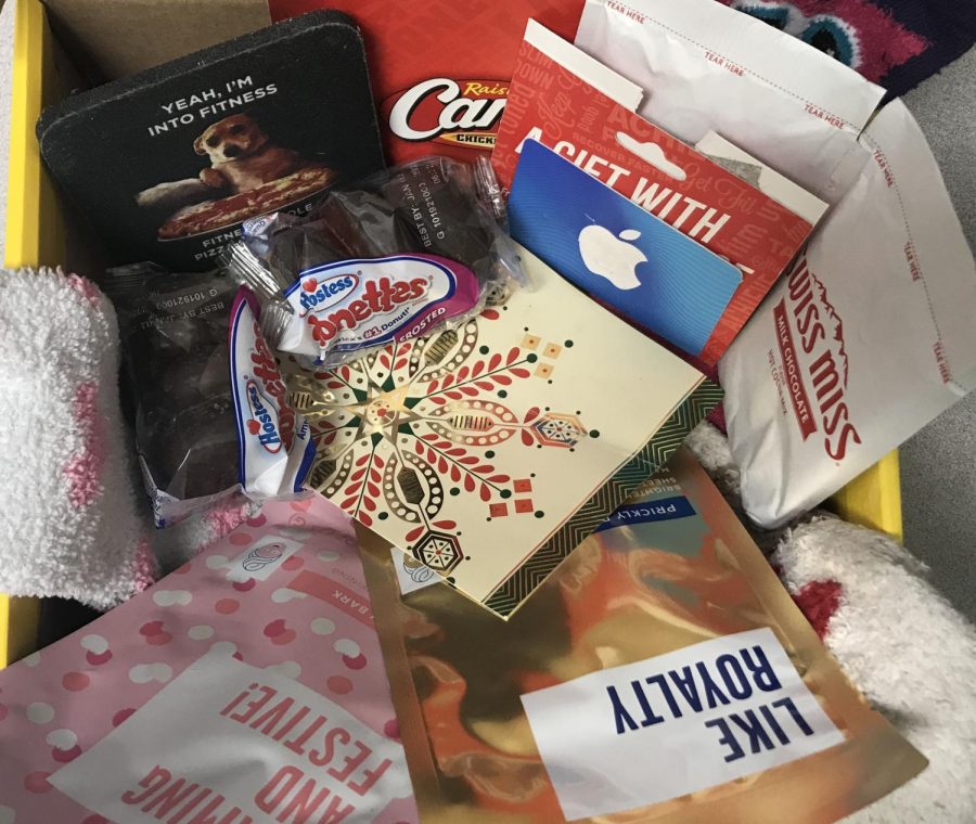 The Gift of Self-Care: With a box, bag or basket, he present of self care can help a family member or friend going through stressful holiday shopping and finals during the school year. Adding in small things like a funny coaster for drinks, packed food such as donuts and a card wishing them a Happy Holiday