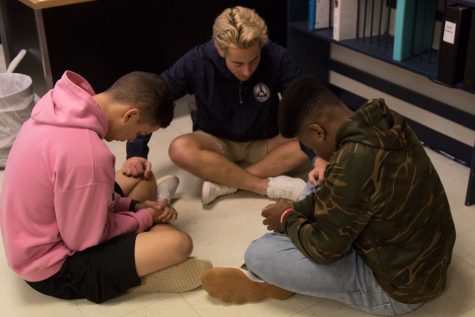 Senior Allen Butterfield prays over freshman Lucas Schuster and junior Tyler Hoskins. This particular meeting was all about being there for your friends and supporting them. The participants met in small groups and poured their hearts out. They shared their struggles, their praises, and their love for the Lord.  