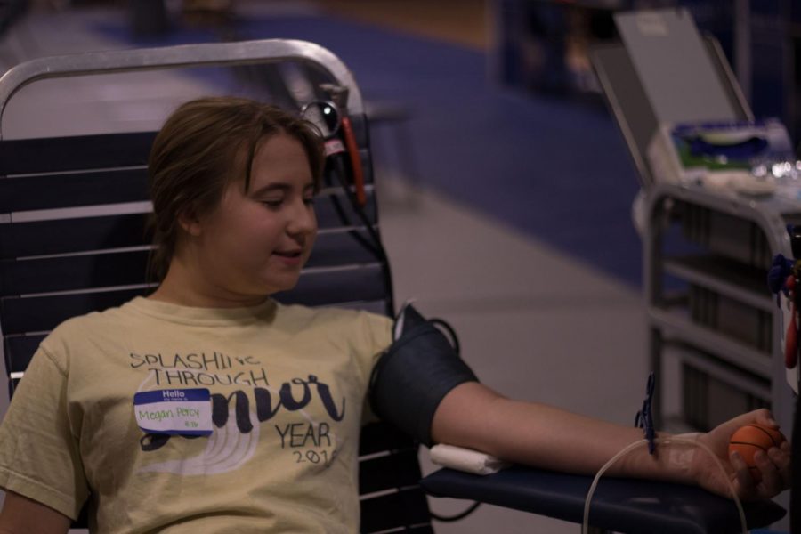 Megan Percy gives blood at StuCo's annual blood drive. Though initially terrified to d this, she powered through and conquered her fears to help others. 