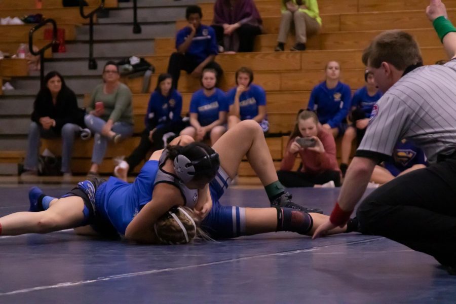 Senior and only returning member of the girls wrestling team, Sophia Tran, holds her opponent down in a match against Seckman High School. Constantly facing different opponents has allowed tran to develop the skills that allowed her to qualify for state alongside freshman Sophia Miller.